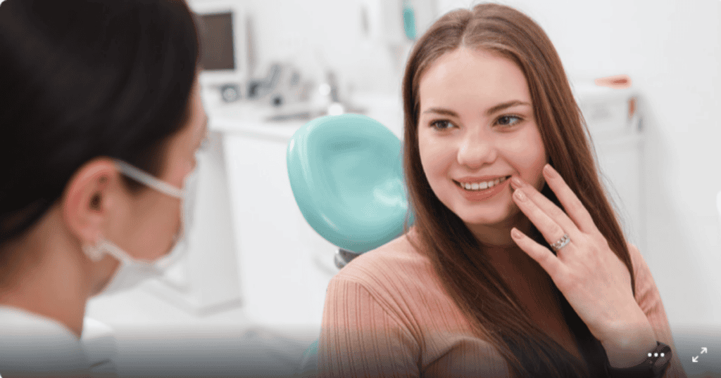 teen girl in dental chair talking to doctor about Wisdom tooth surgery preparation